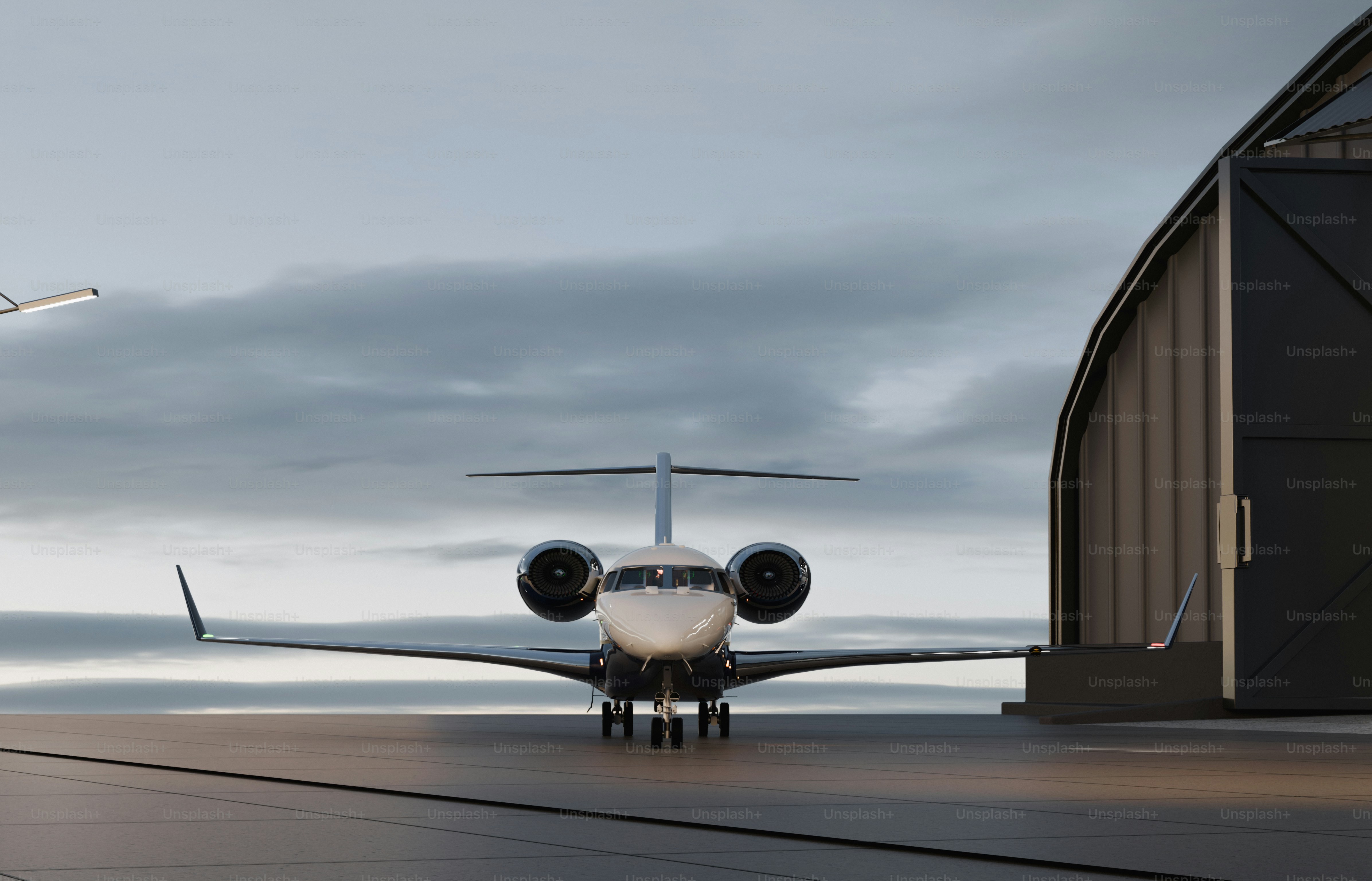Private jet parked outside a modern hangar